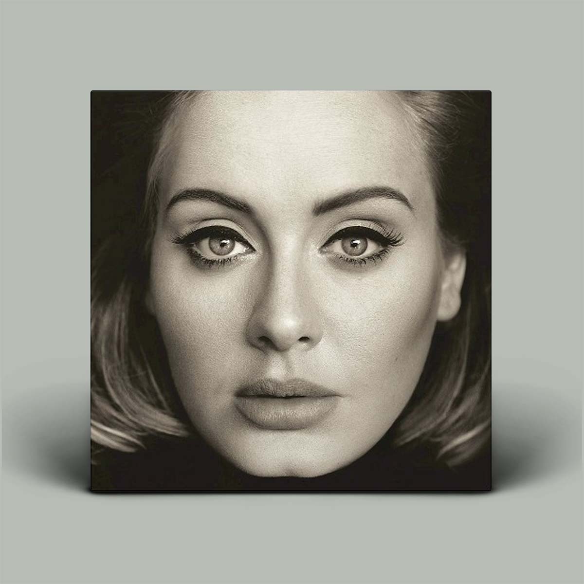 Black and white portrait of a woman with a neutral expression on a gray background