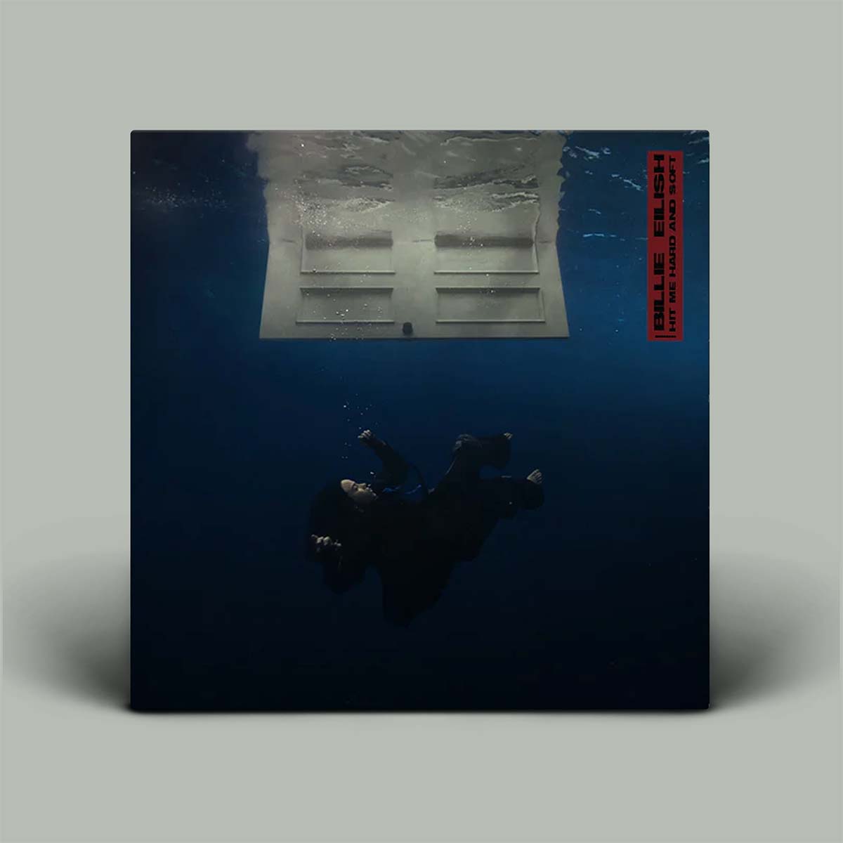 Vinyl record with a blue cover featuring a person lying on the ground and a red label.