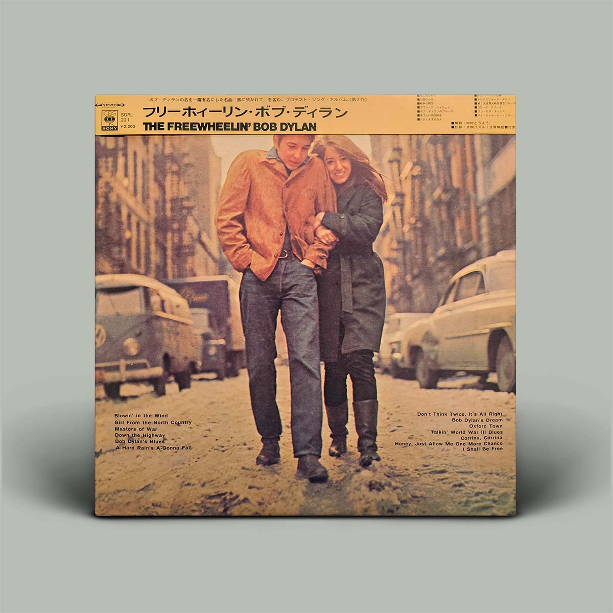 Vinyl record cover with two people standing on a street, vintage cars in the background