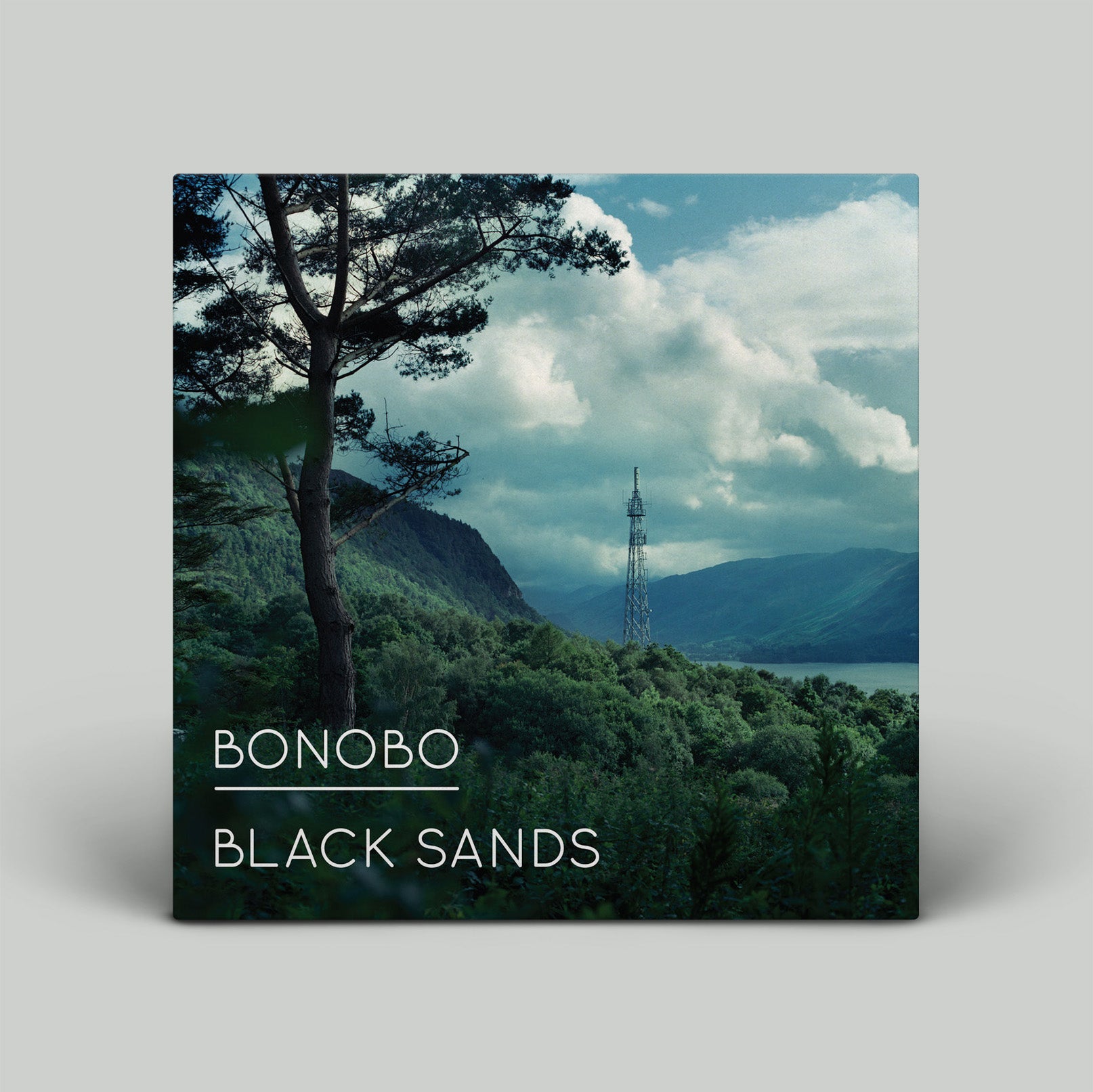 Album cover for 'Black Sands' by Bonobo with a scenic landscape.