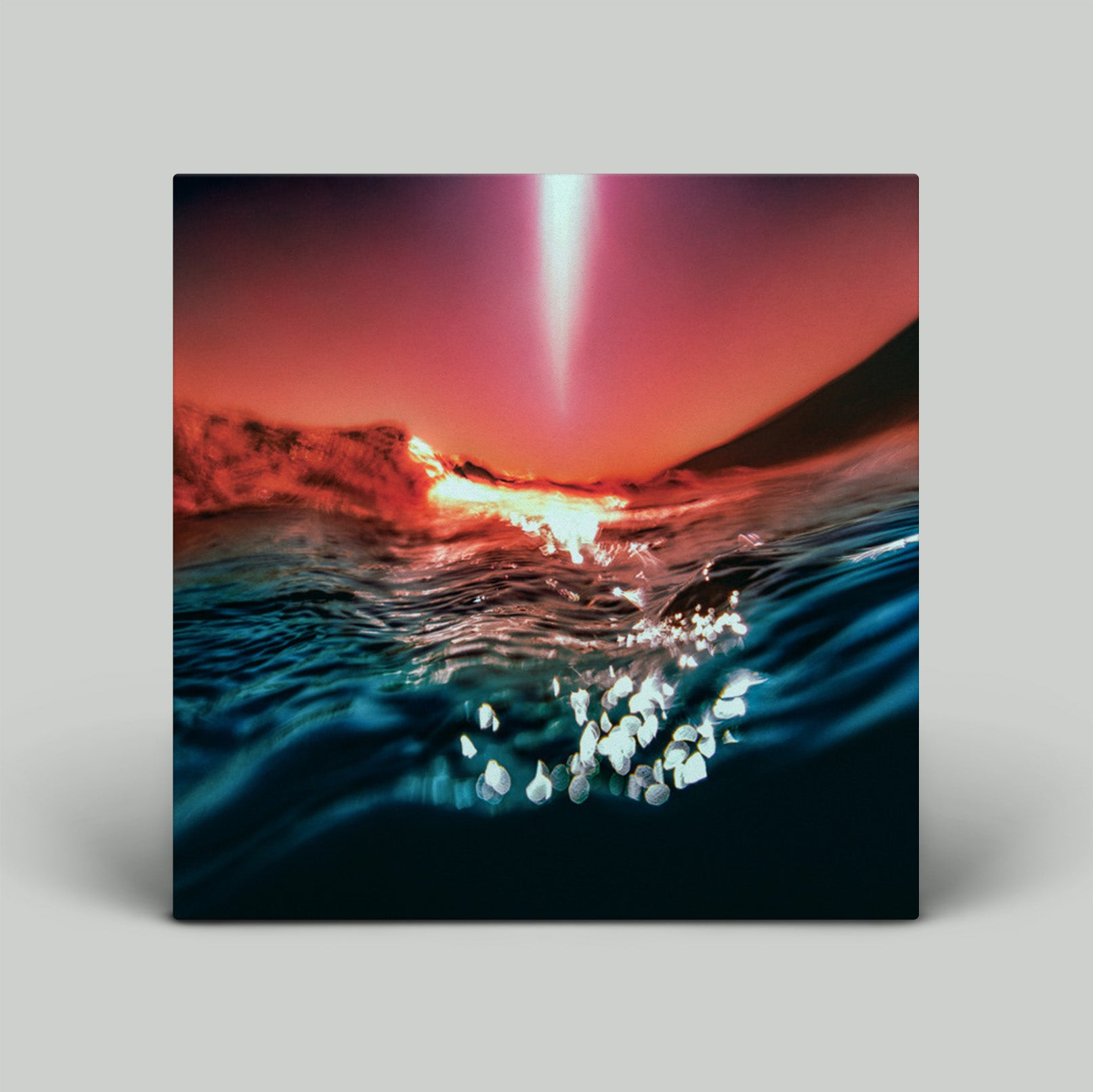 Surreal sunset over water with a bright light source