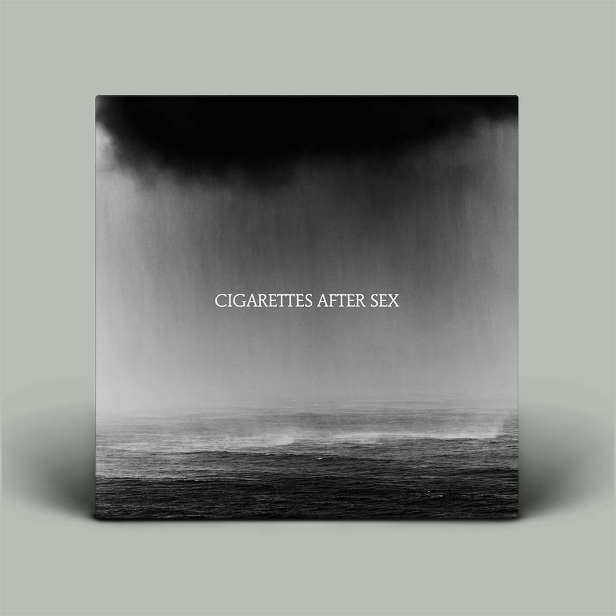 Album cover with 'Cigarettes After Sex' text over a black and white landscape.