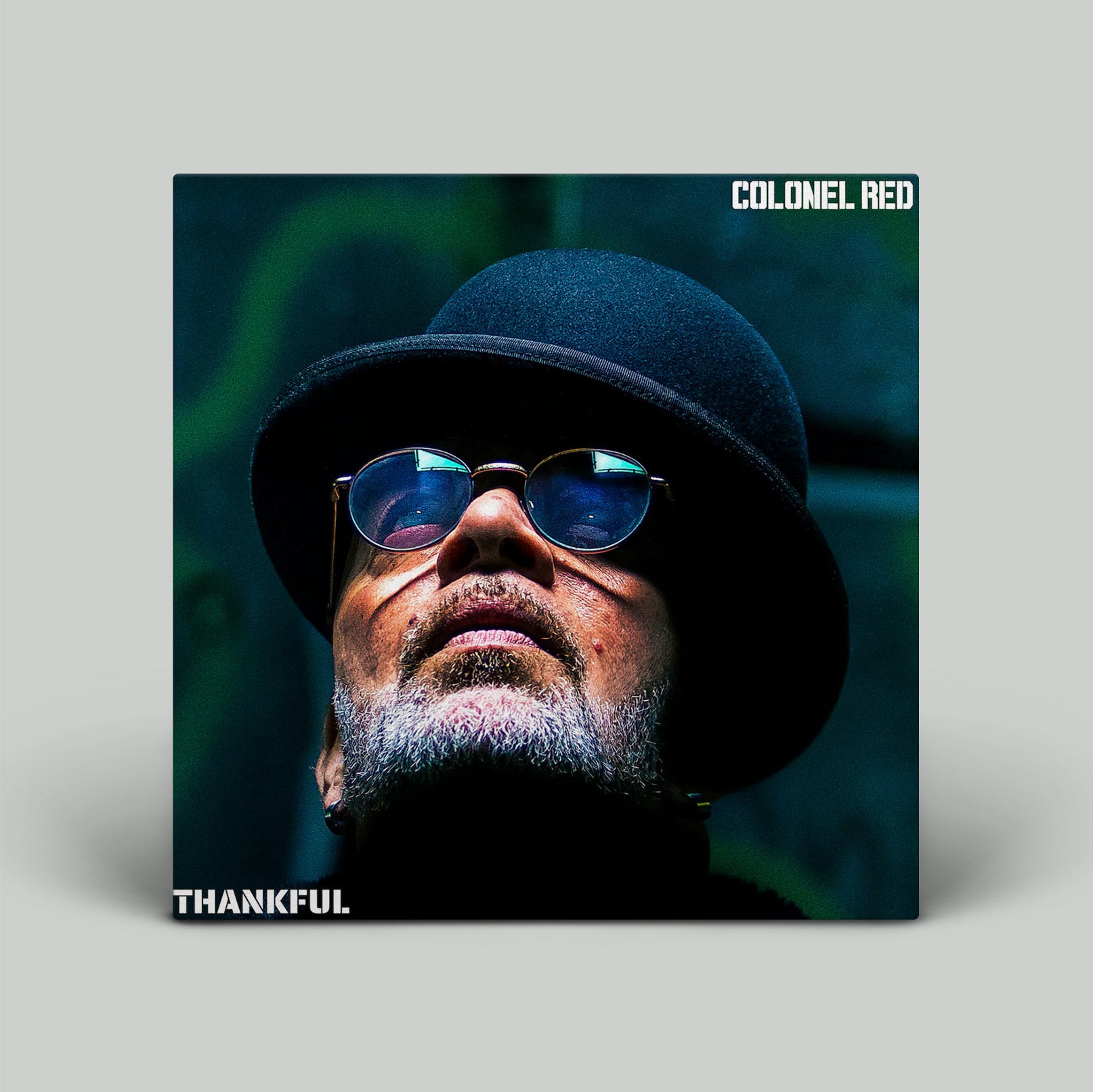 Album cover with a person wearing a hat and sunglasses, featuring the text 'Colonel Red' and 'Thankful'.