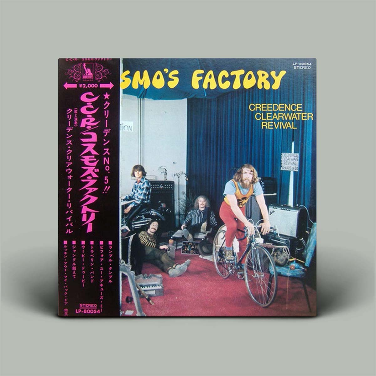 Vinyl record cover for Creedence Clearwater Revival's 'Cosmo's Factory' with band members and bicycle on a grey background