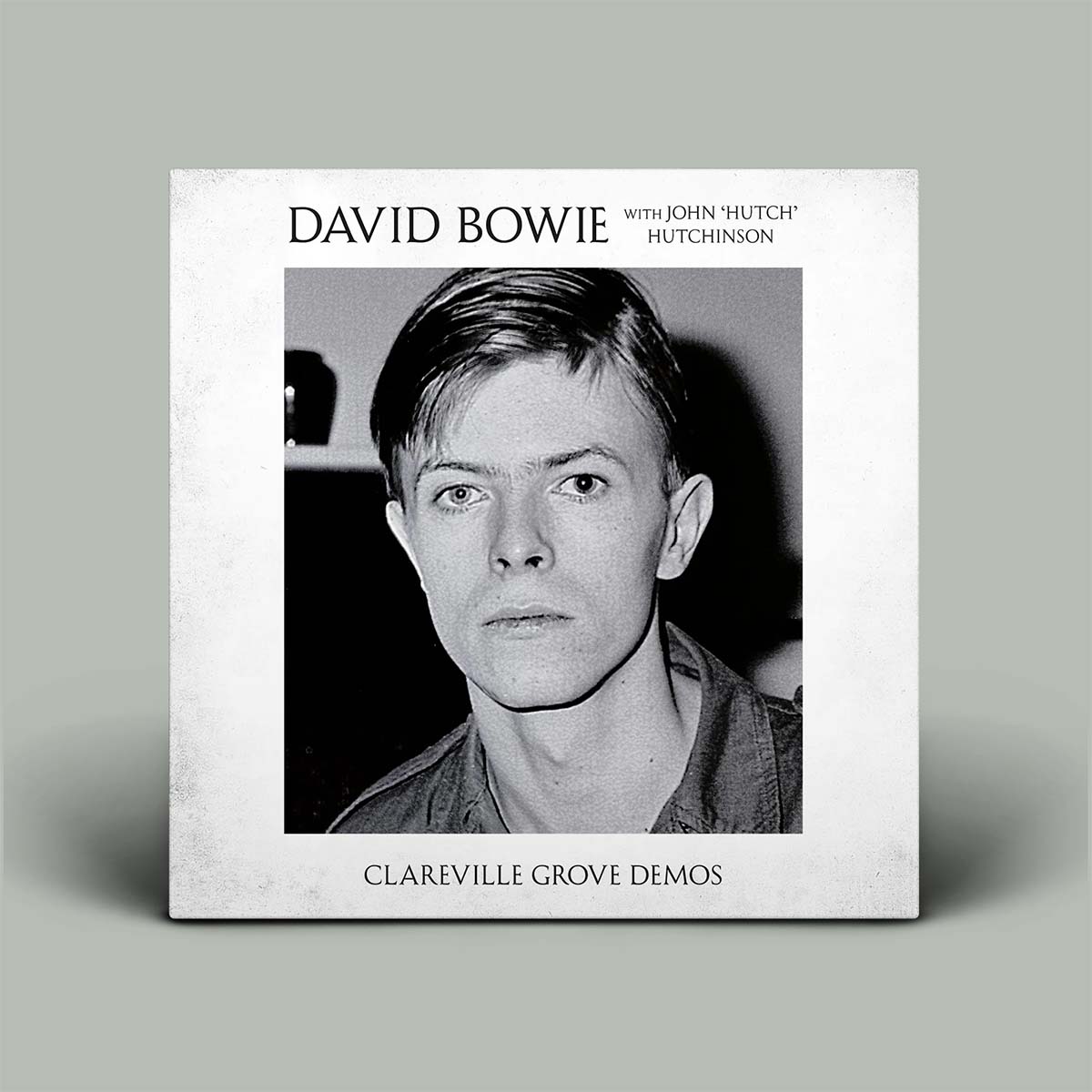 Album cover is a black and white photograph of Bowie with white border.