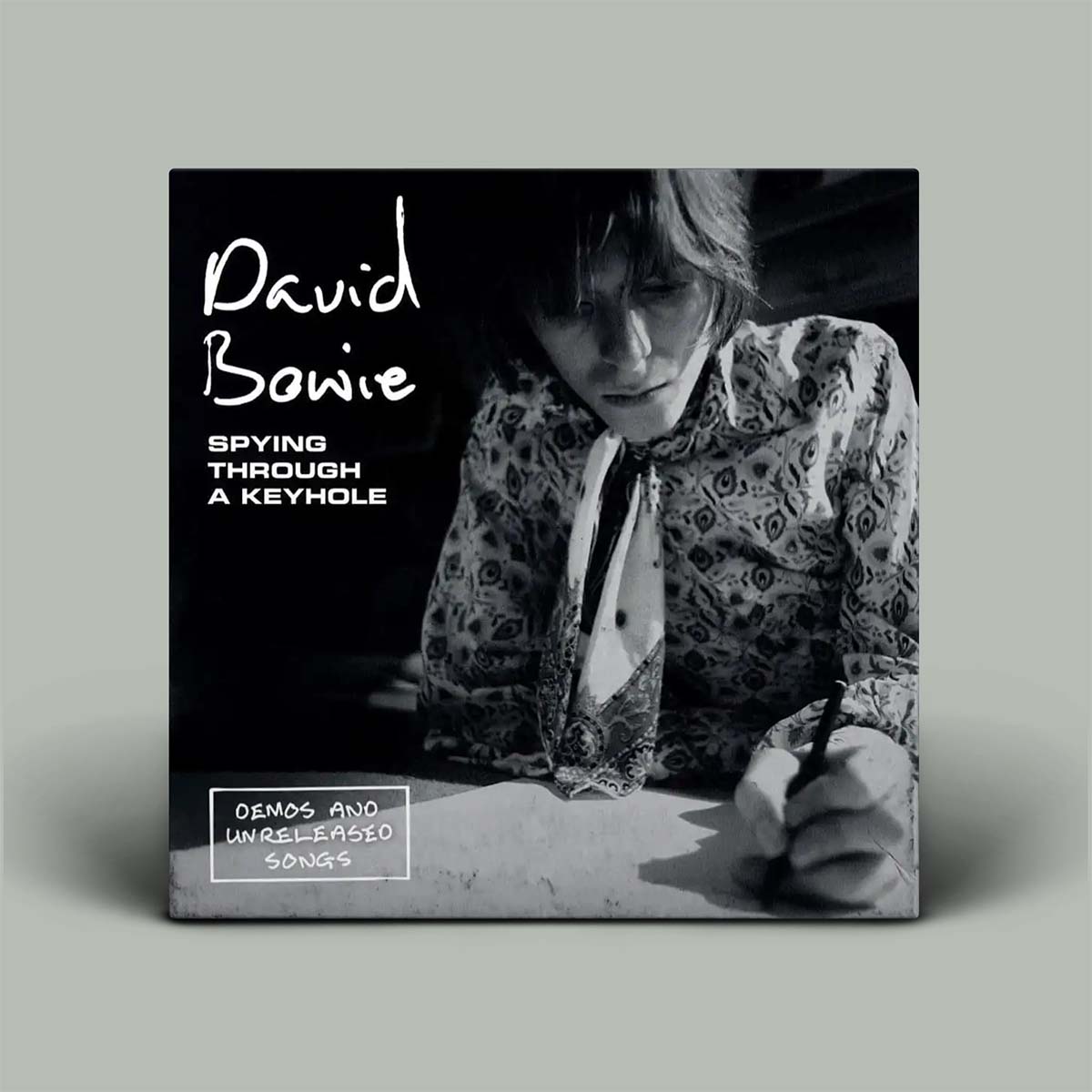 Album cover featuring David Bowie with text 'Spying Through A Keyhole' and 'Demos and Unreleased Songs'.