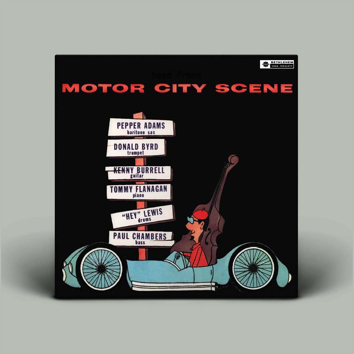 Album cover for 'Motor City Scene' with a cartoon character driving a car and a list of musicians on a scoreboard.