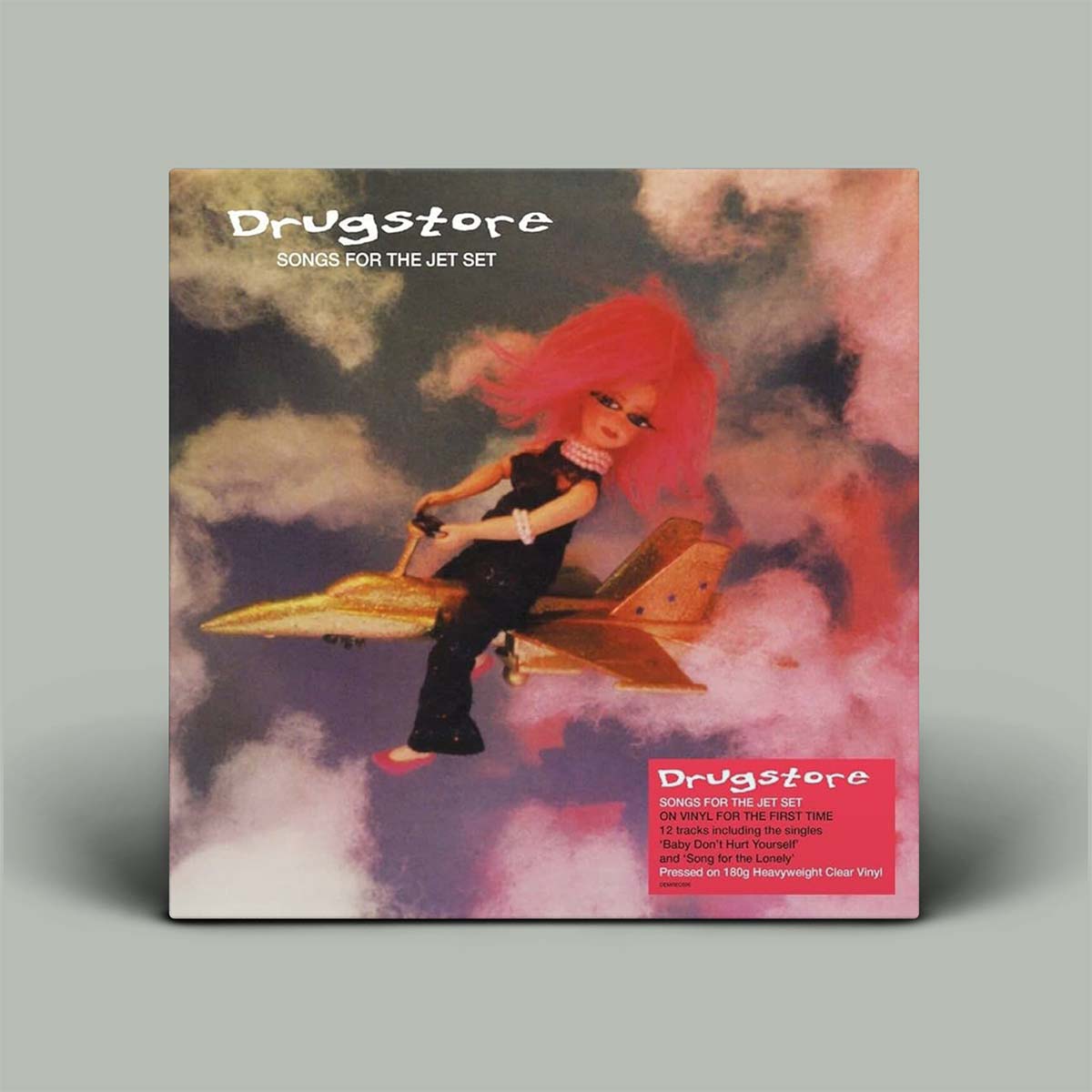 Album cover for 'Drugstore: Songs for the Jet Set' with a person on a gold airplane against a colorful sky.