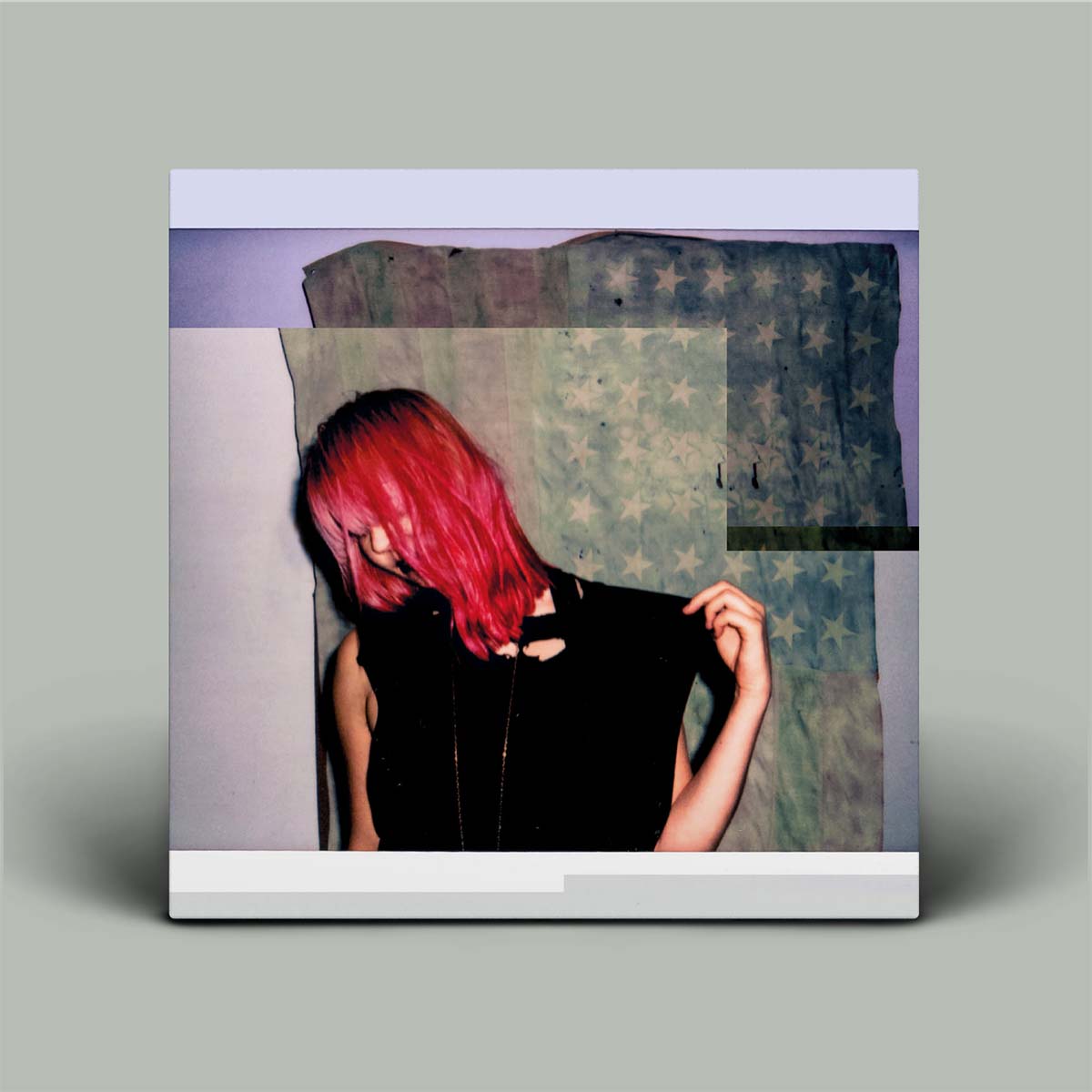 Album cover with a person with red hair and a patterned background