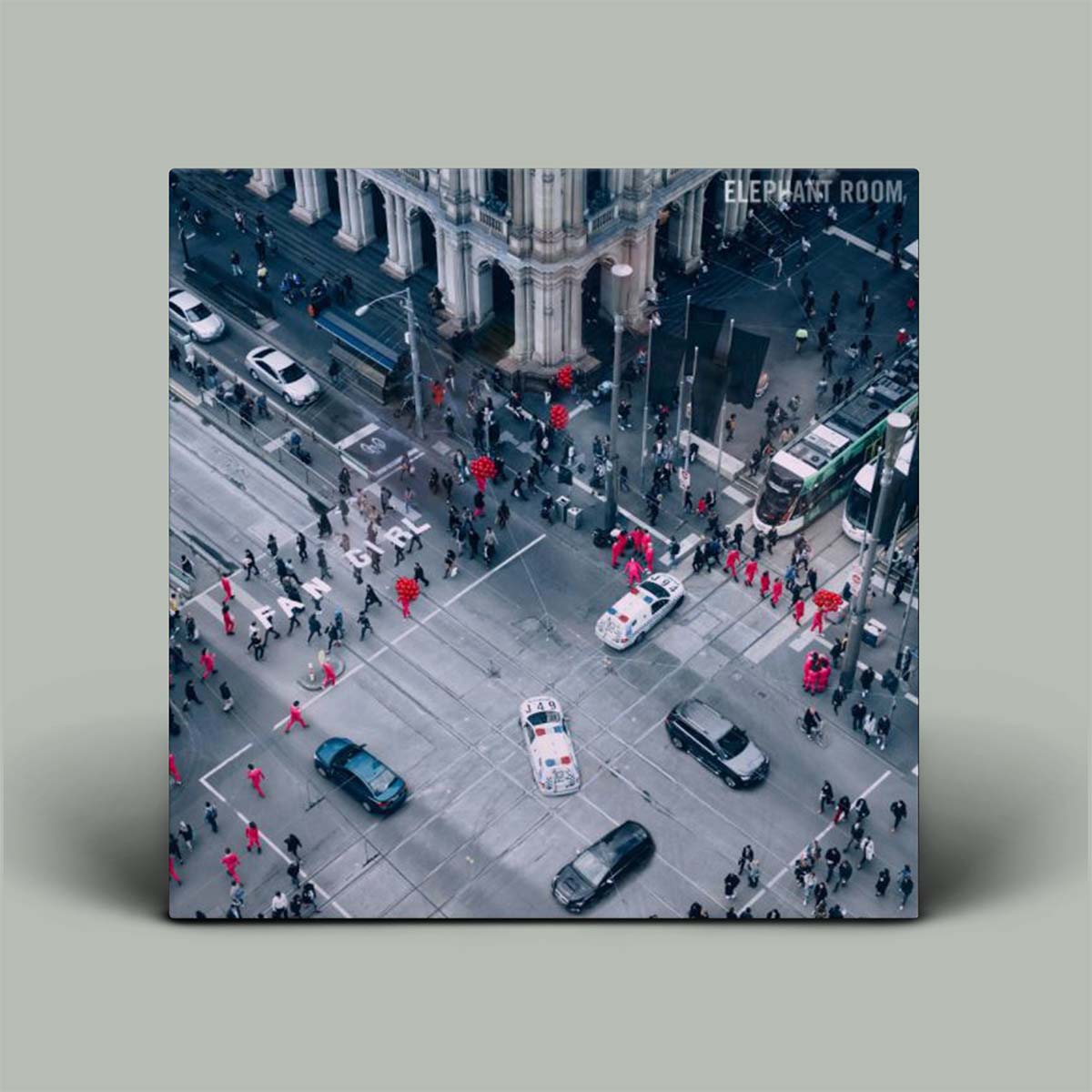 City street scene with people, cars, and a large building on a gray background