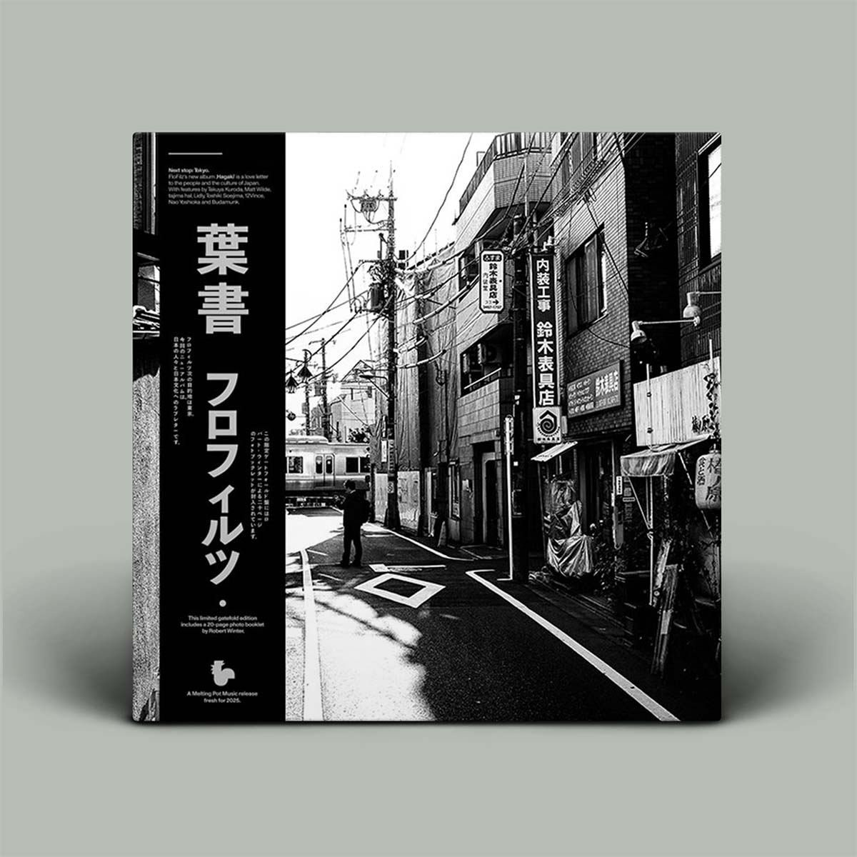 Album cover with black and white photo of a street scene in Japan with Japanese text