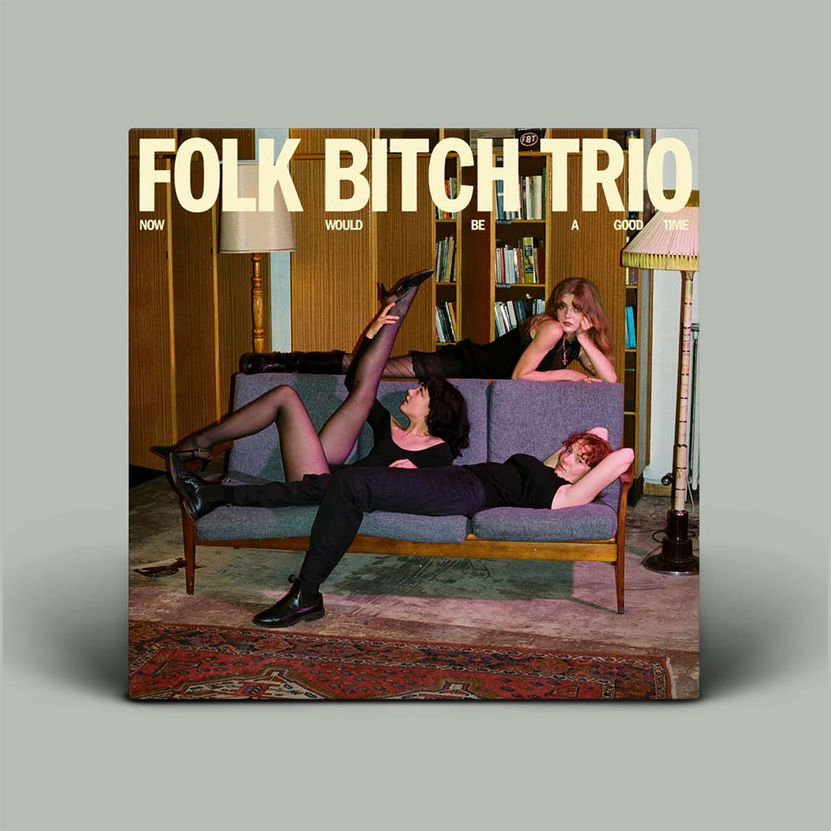 Album cover with three people on a couch and text 'Folk Bitch Trio' above them.