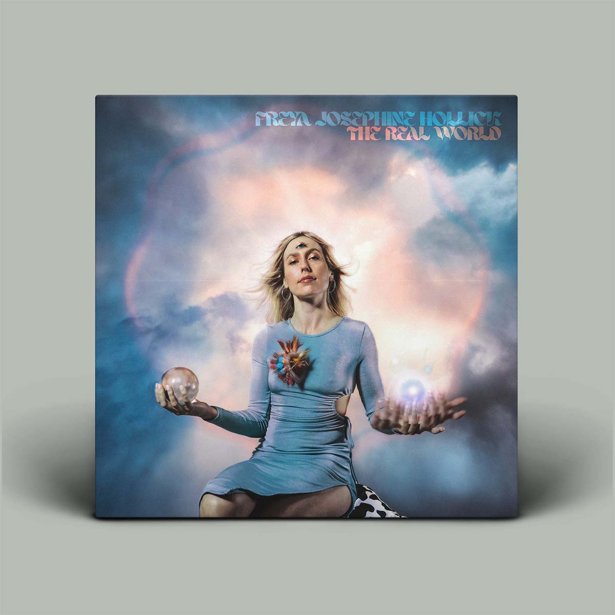 Album cover with a person holding glowing objects against a cloud-like background