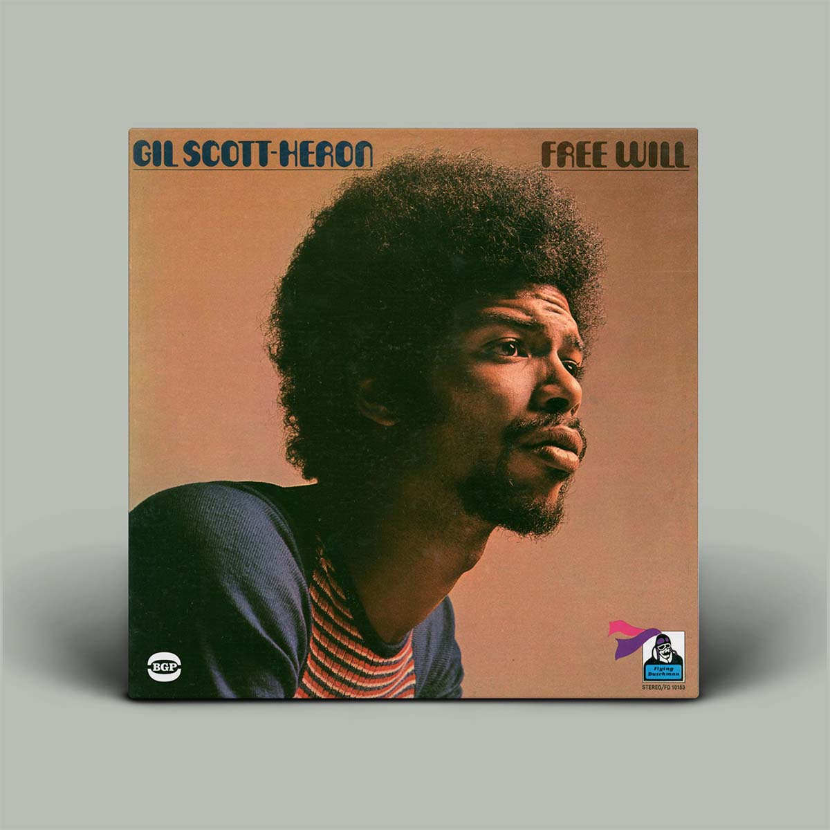 Vinyl album cover featuring a portrait of Gil Scott-Heron with 'Free Will' text on a brown background.