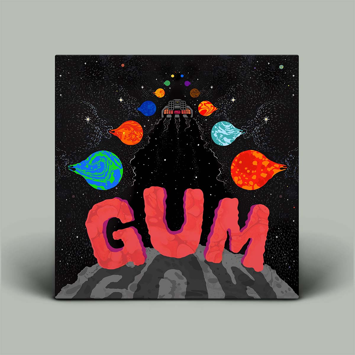 Album cover with 'GUM' text and space-themed design on a gray background