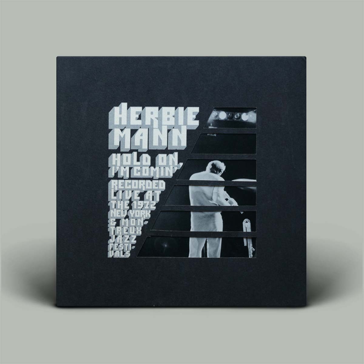 Album cover with text and a black and white photo of a person on a gray background