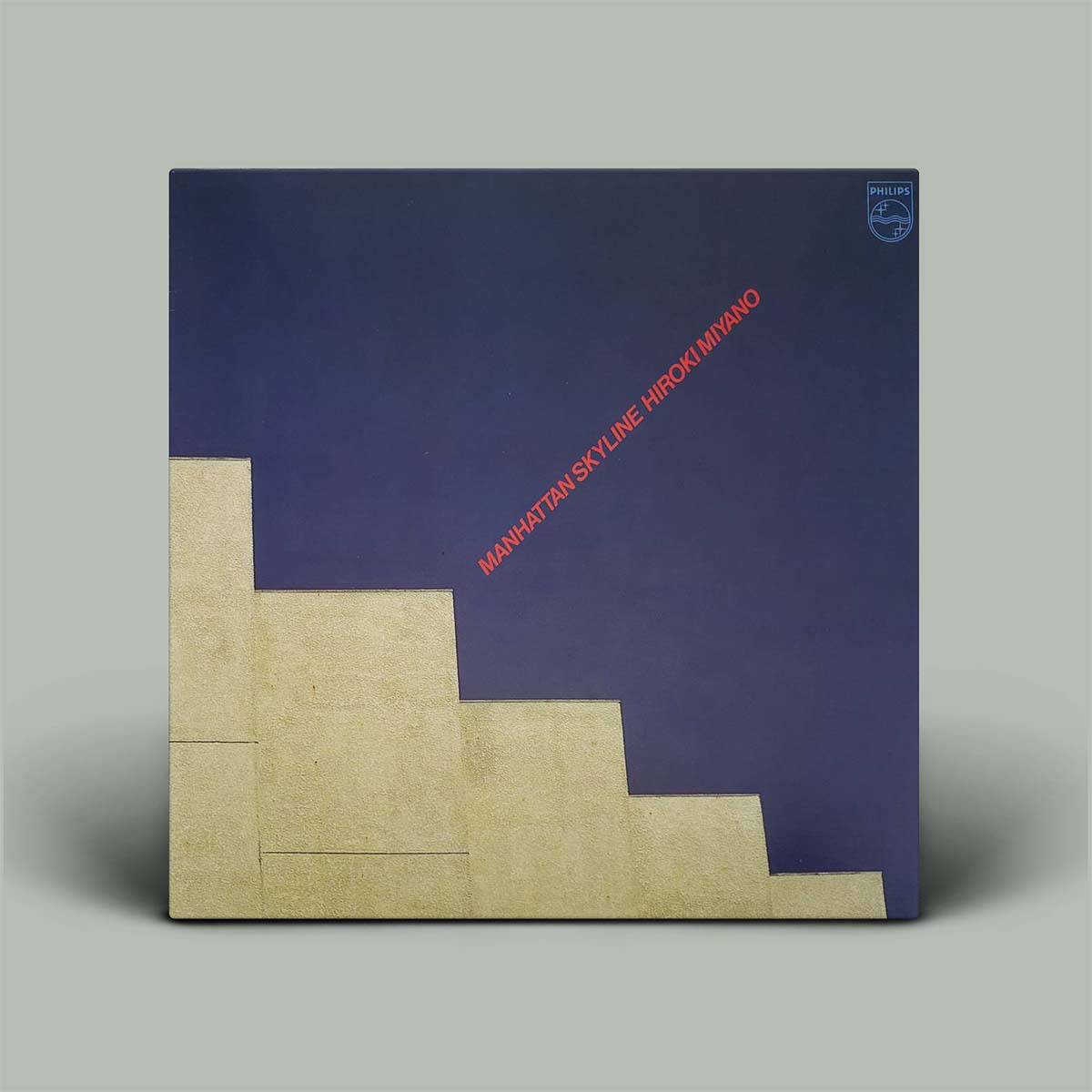 Album cover with blue and beige design and text on a gray background