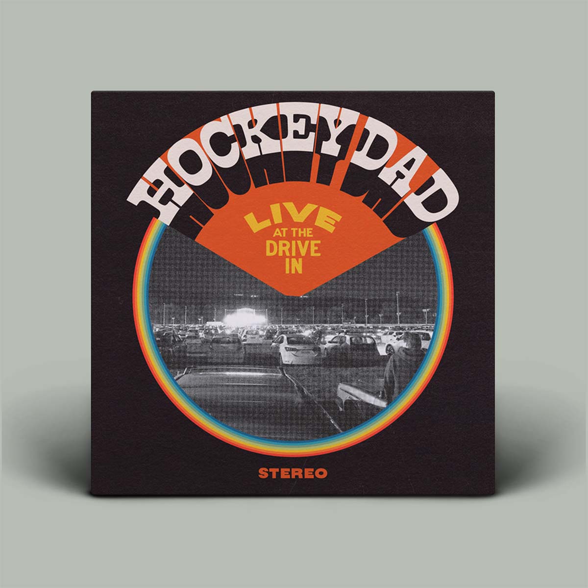 Album cover for 'Hockey Dad Live at the Drive In' with a retro design.