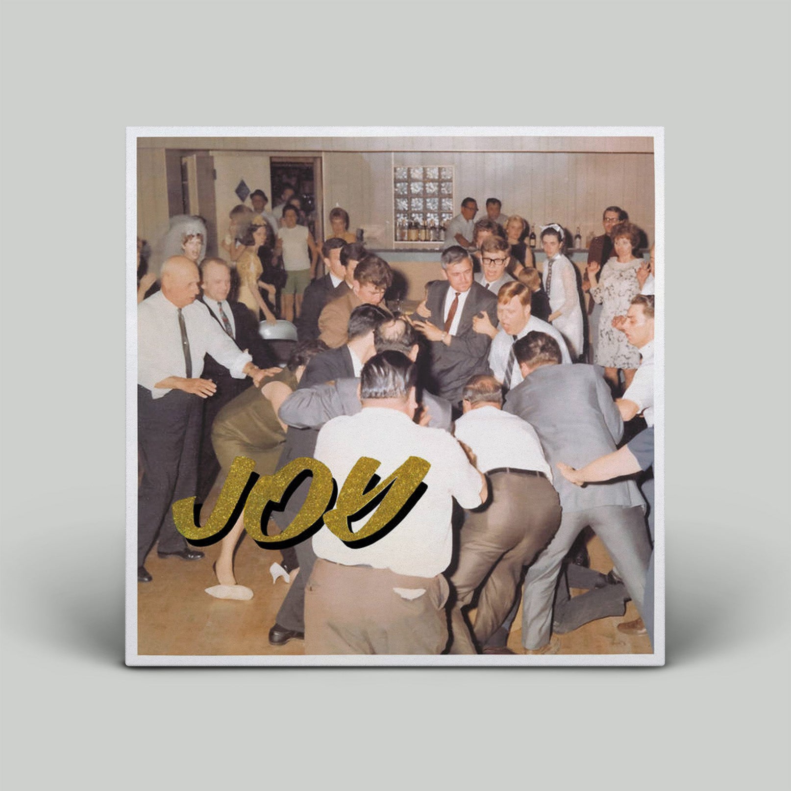 Album cover with a group of people dancing and the word 'JOY' in gold.