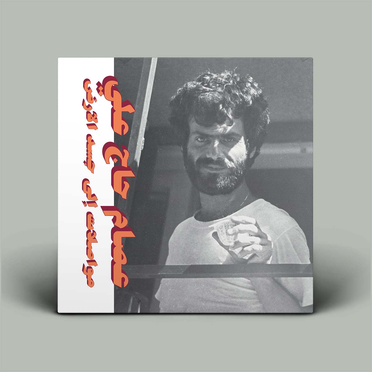 Album cover with a black and white photo of a man and red text on a gray background