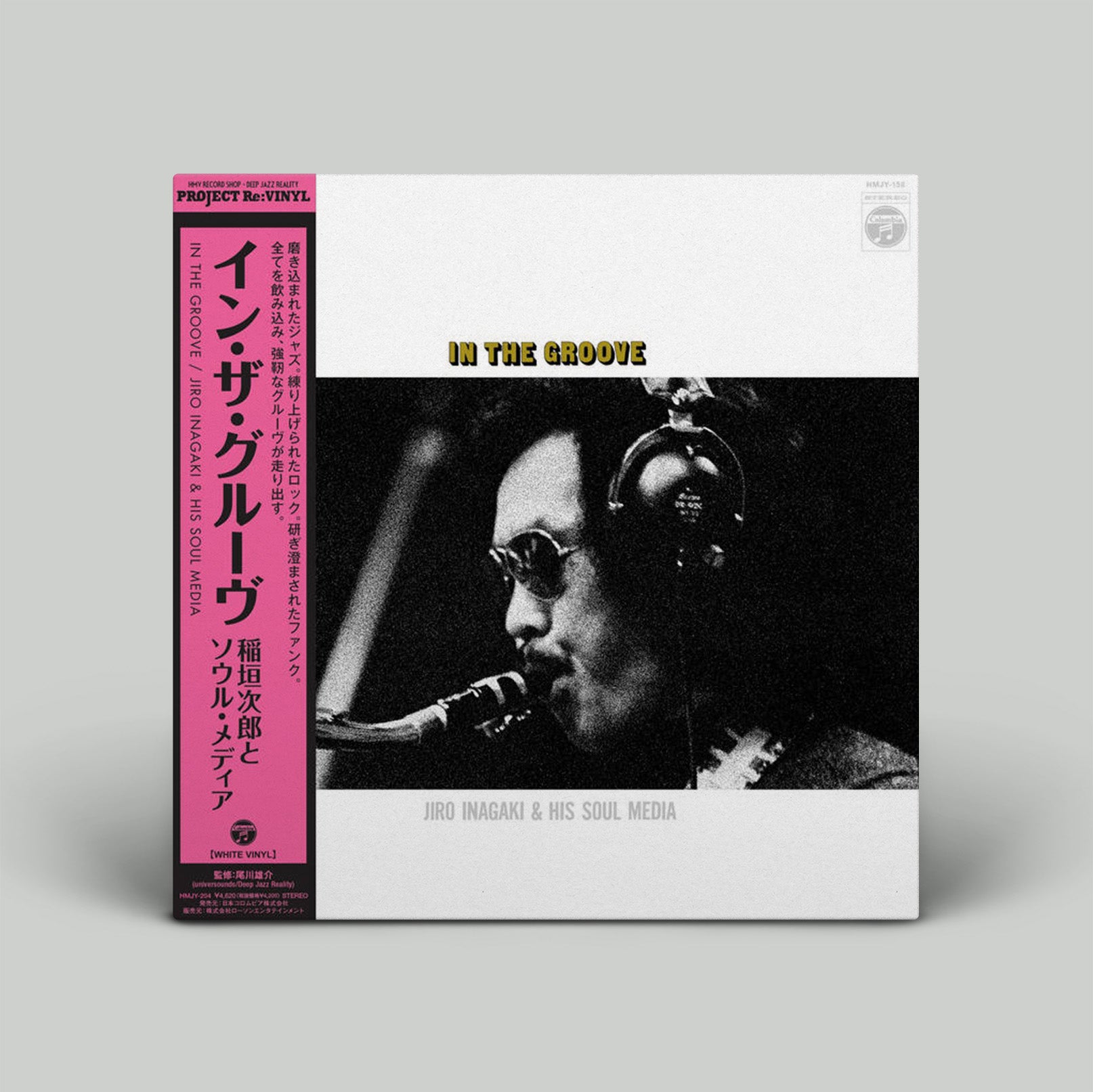 Vinyl record cover with a black and white photo of a person playing saxophone, pink text on the left, and 'In the Groove' text at the top.