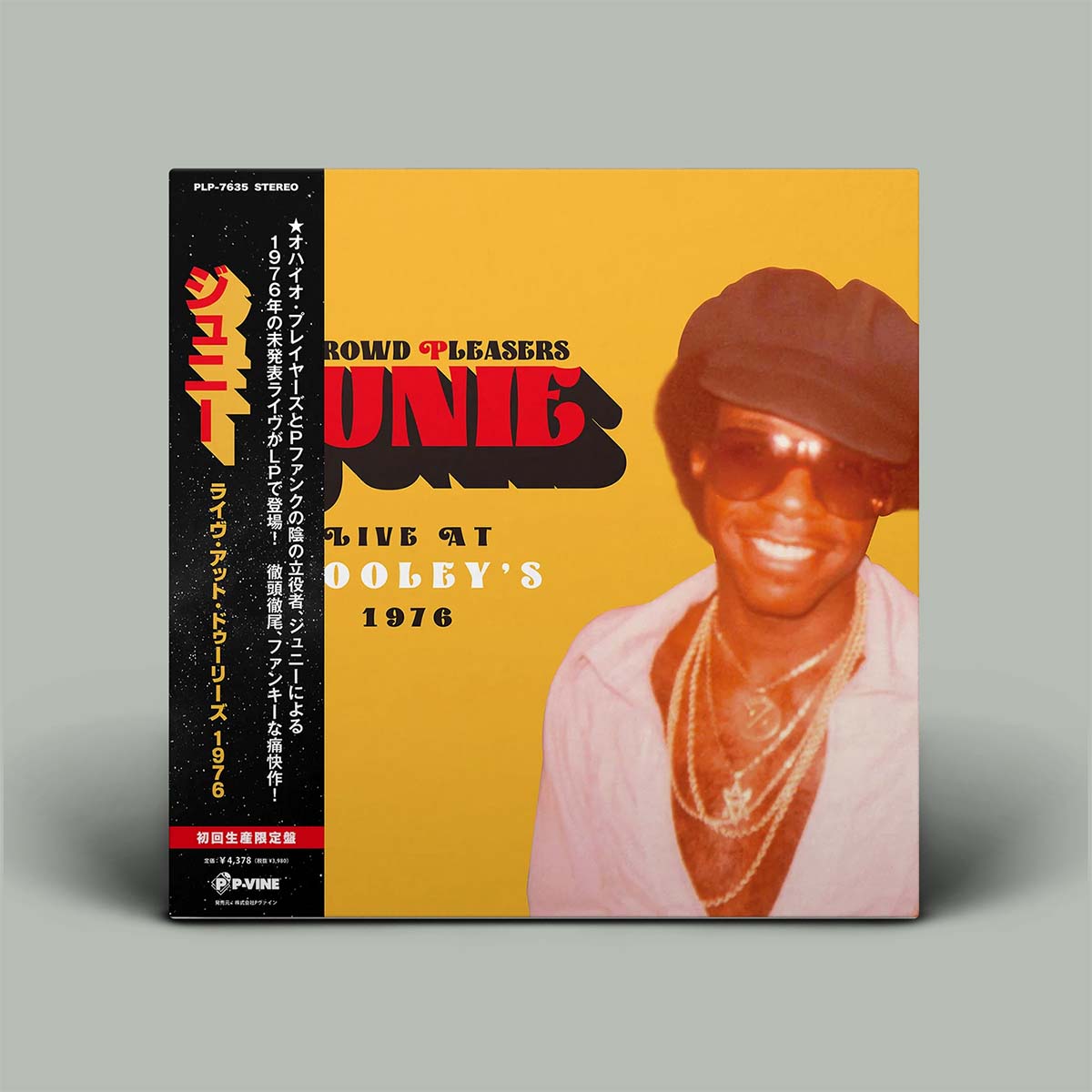 Album cover with a person wearing sunglasses and a hat on a yellow background