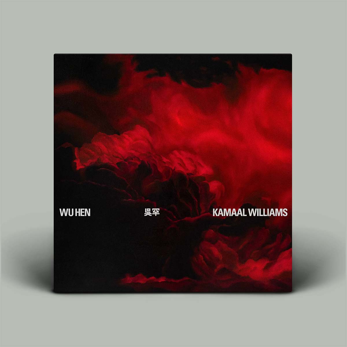 Album cover with red and black abstract design and text 'WU HEN' and 'Kamaal Williams'.