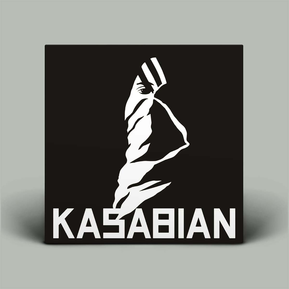 Kasabian album cover with a stylized face and 'Kasabian' text on a black background.