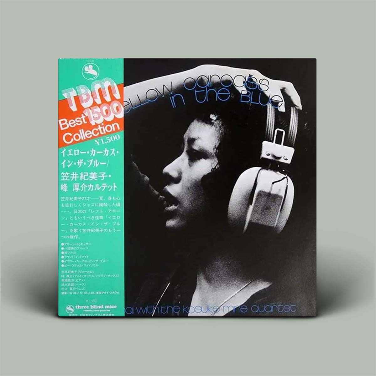 Vinyl record cover with a person wearing headphones and text on a gray background