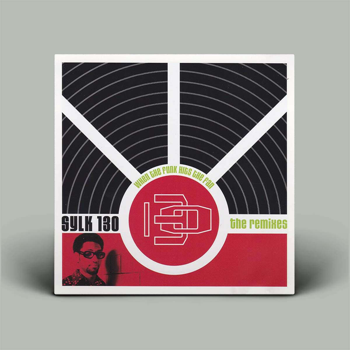 Album cover with a stylized record design and text on a gray background