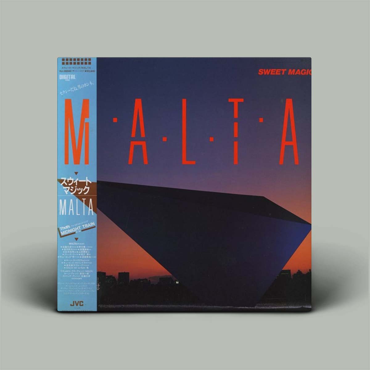 Vinyl record with 'MALTA' and 'Sweet Magic' text on a gray background