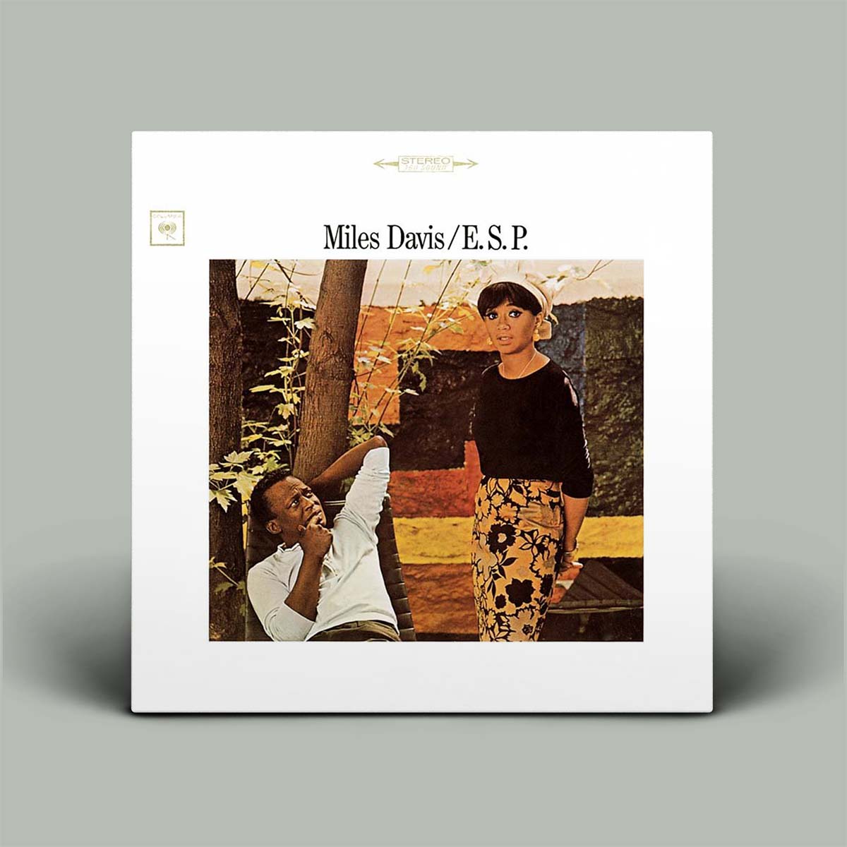 Album cover of 'E.S.P.' by Miles Davis featuring two people sitting outdoors.
