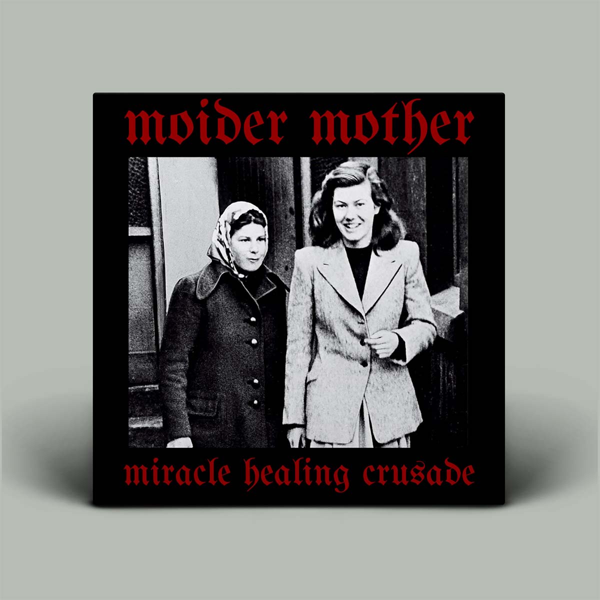 Album cover with black and white photo of two women with black background and red writing.