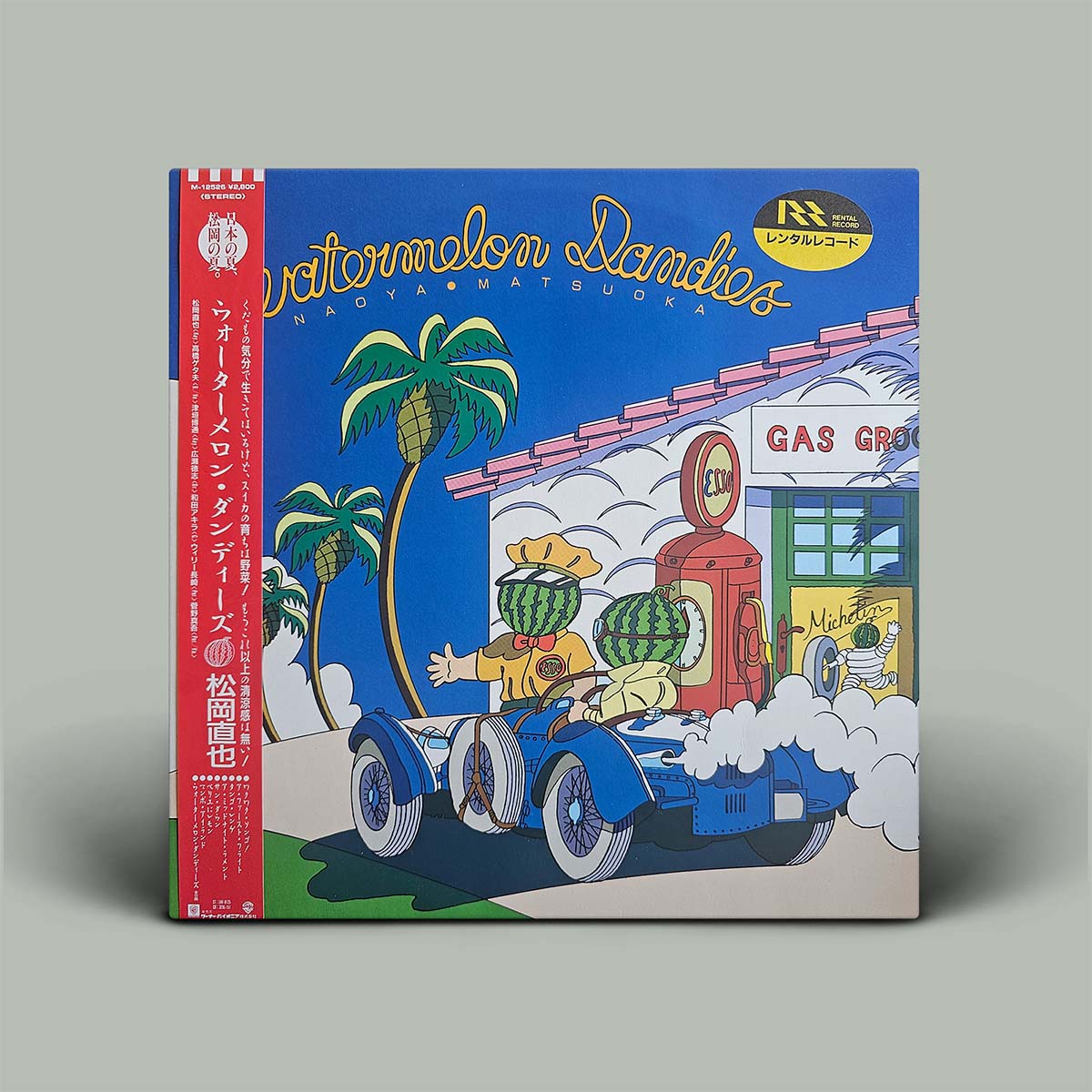 Colorful album cover with cartoon character driving a car, palm trees, and gas pump on a gray background