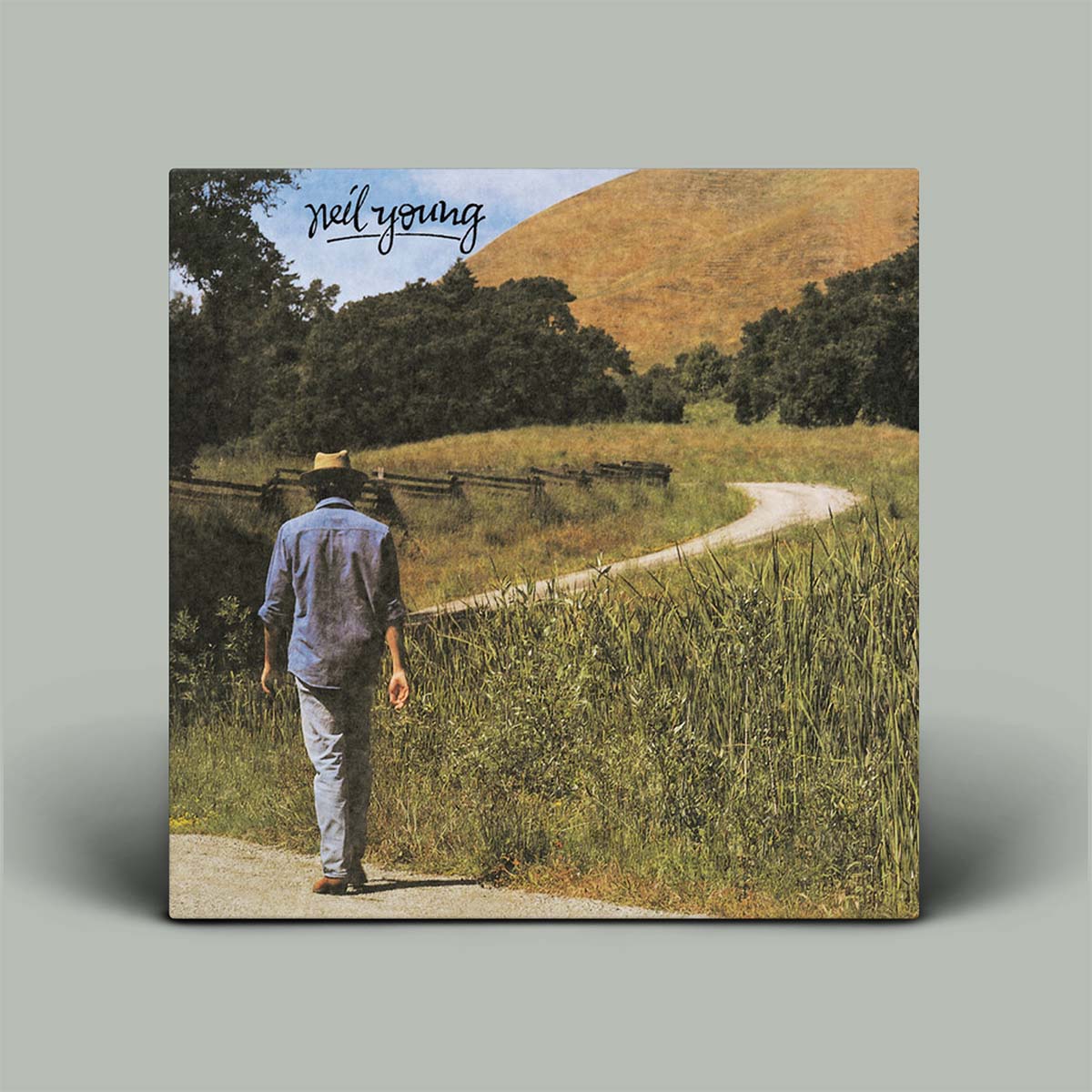 Album cover with a person walking along a path in a field, featuring the name 'Neil Young'.