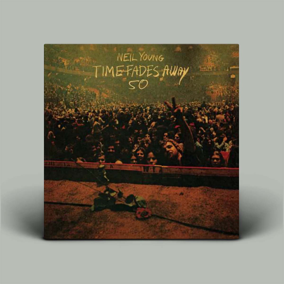 Album cover for 'Time Fades Away' by Neil Young with a crowd scene and rose.