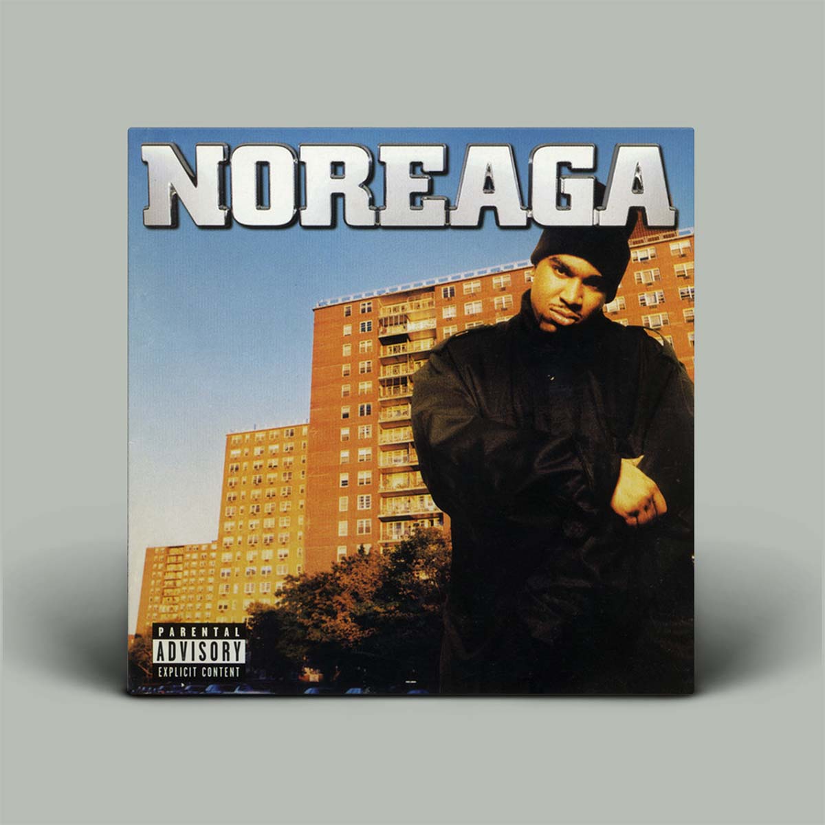 Album cover with a person in front of a building, featuring the title 'Noreaga'.