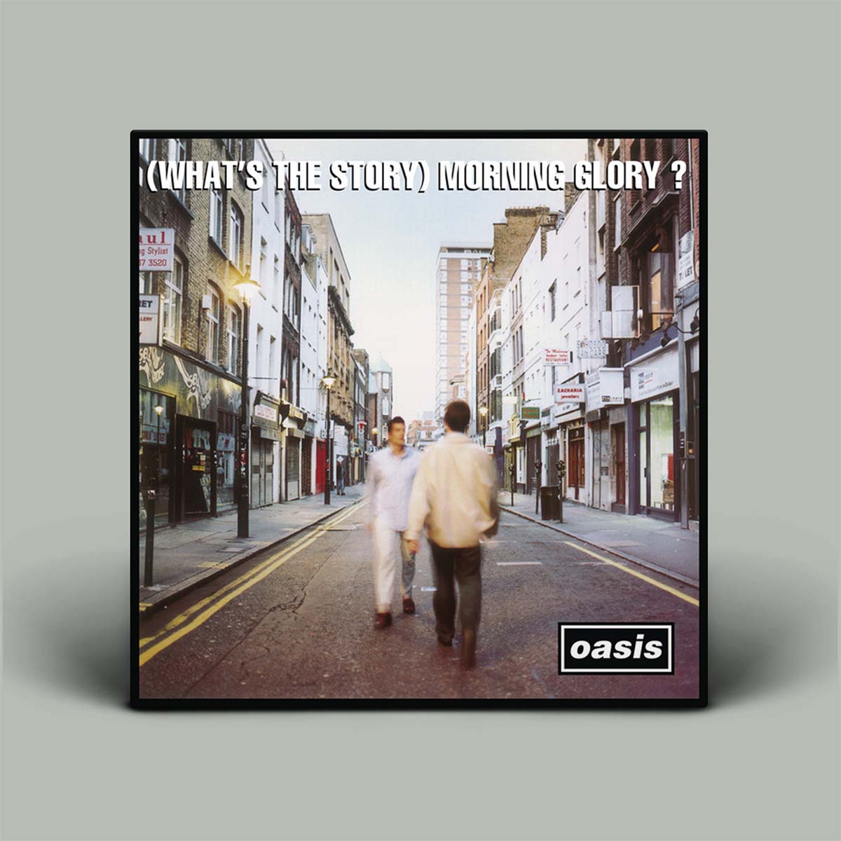 Album cover of 'What's the Story Morning Glory?' by Oasis with two people walking on a street.