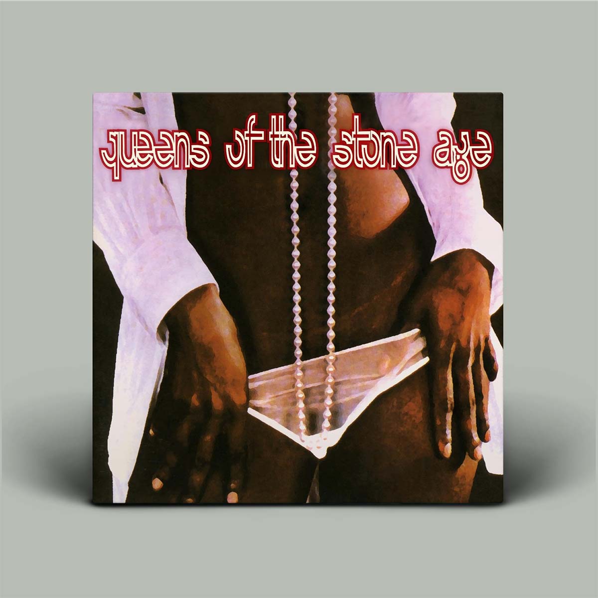 Album cover with ladies torso, pearl necklace hanging and hands hanging on underwear with 'Queens of the Stone Age' text.