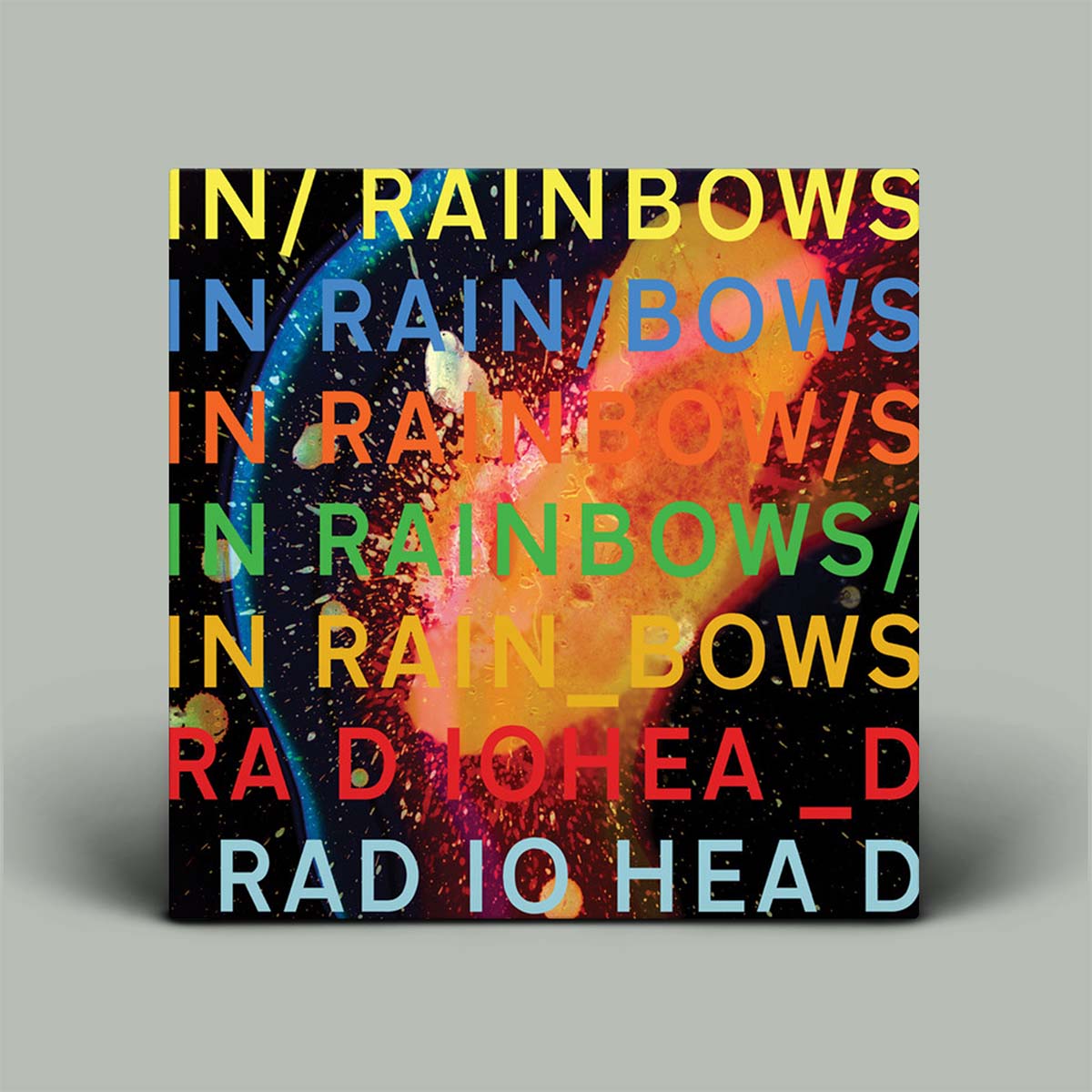 Vinyl record cover for Radiohead's 'In Rainbows' with colorful text and abstract design.