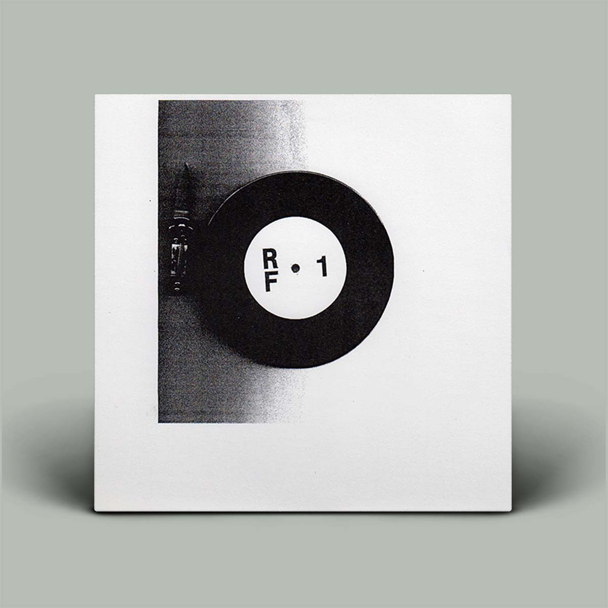 Record cover with a black and white vinyl record design on a gray background