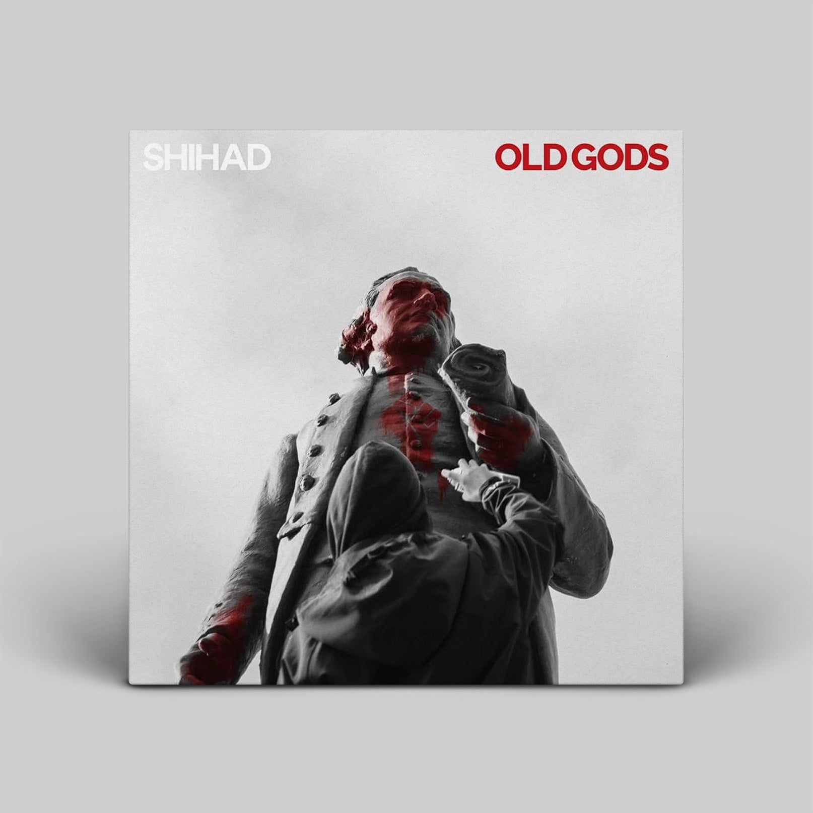 Album cover for 'Old Gods' by Shihad with a person in a suit on a gray background