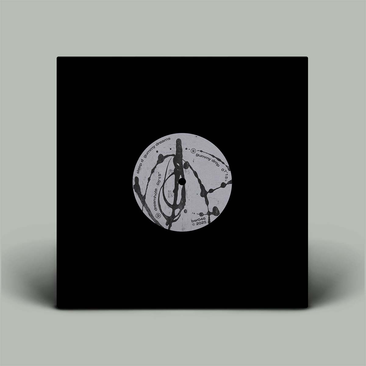 Black vinyl record cover with a circular design on a gray background