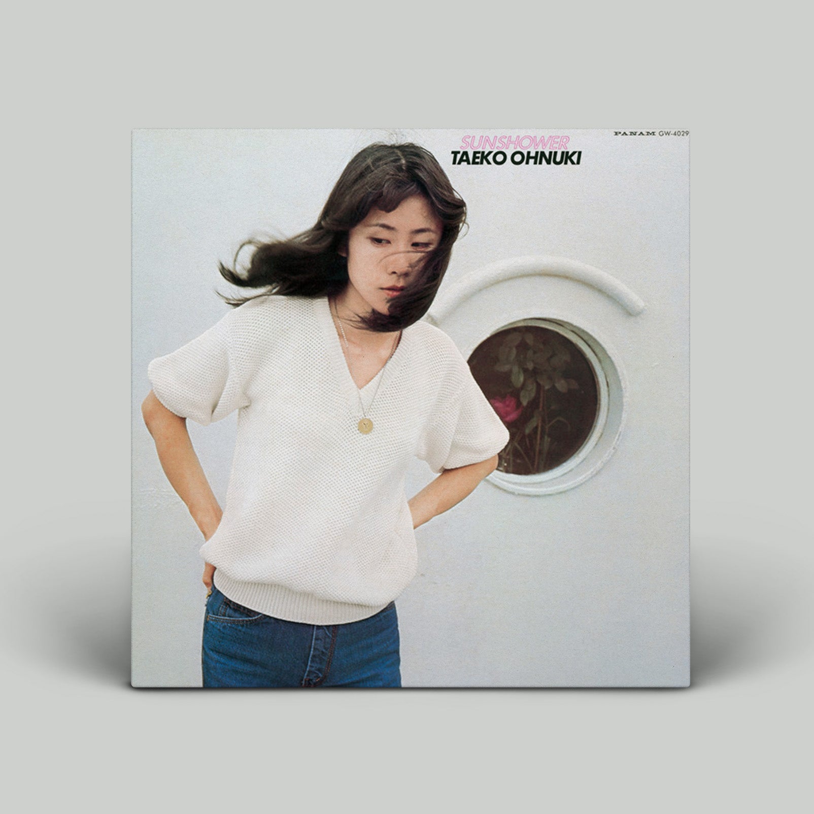 Vinyl record cover with a person and washing machine design, featuring the artist Taeko Ohnuki.