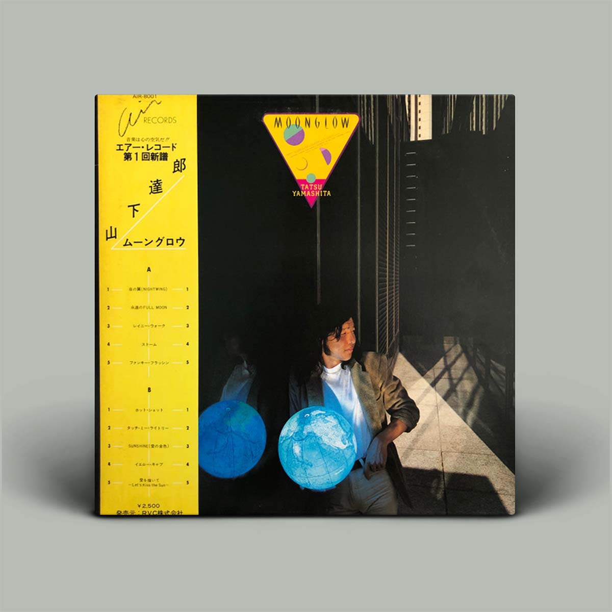 Vinyl record cover with a person holding glowing blue balls against a dark background