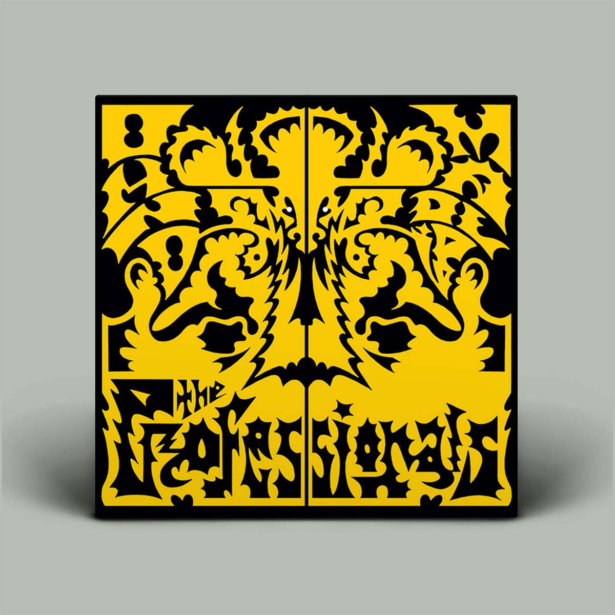 Decorative panel with yellow and black intricate design on a gray background