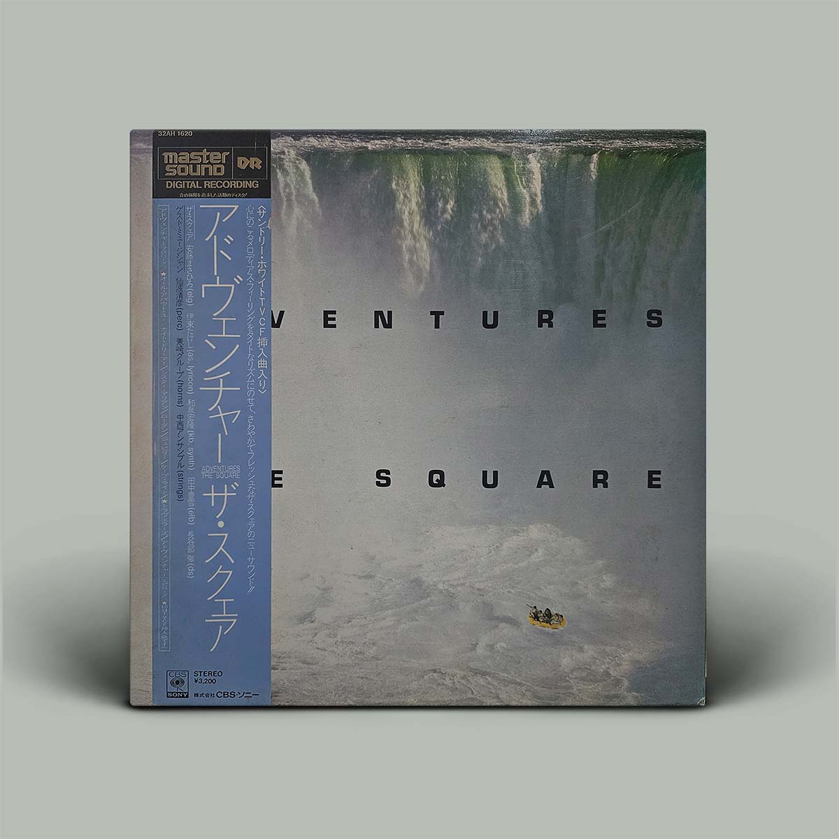 Vinyl record cover with a waterfall and text on a gray background