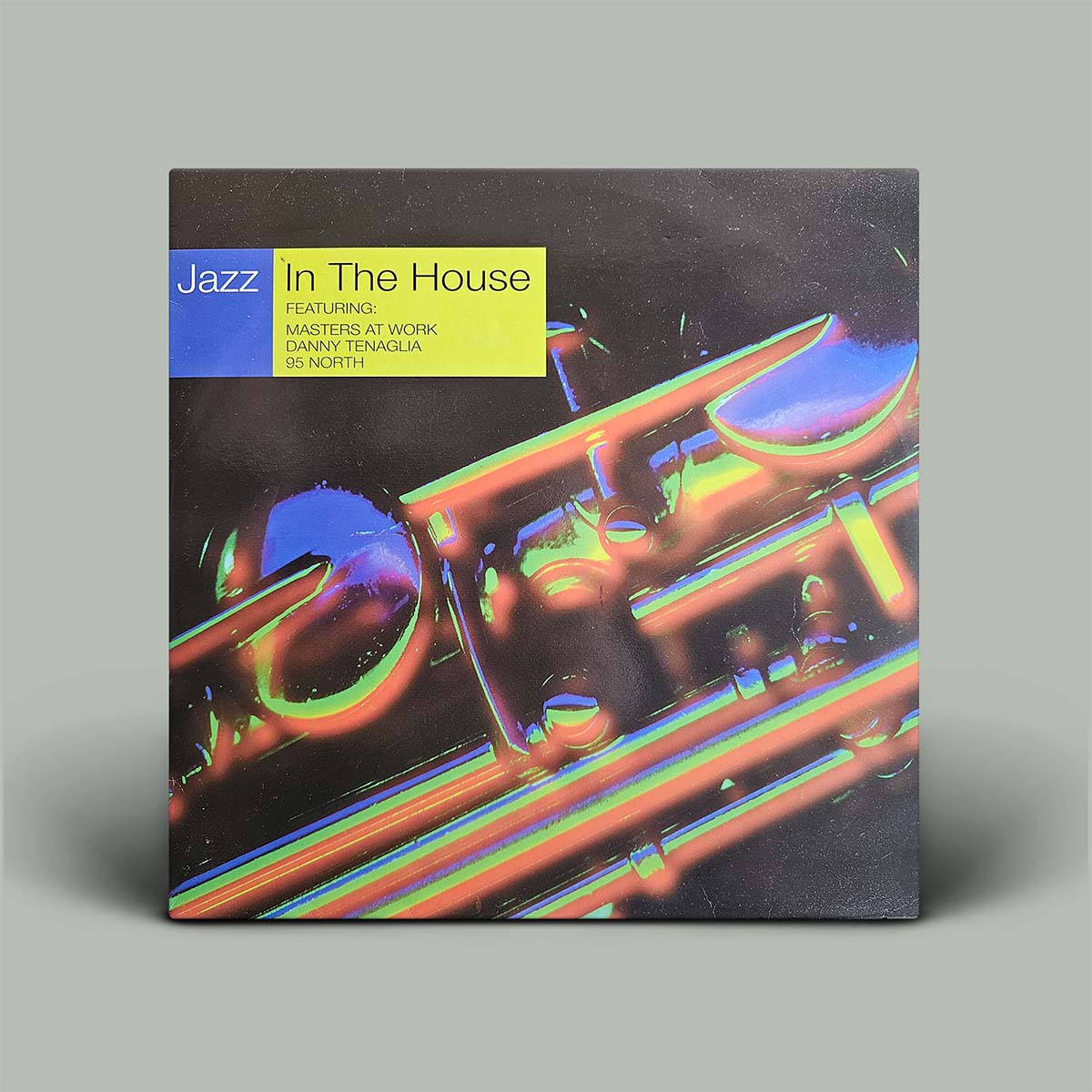 Black album cover with rainbow coloured graphic image on front.