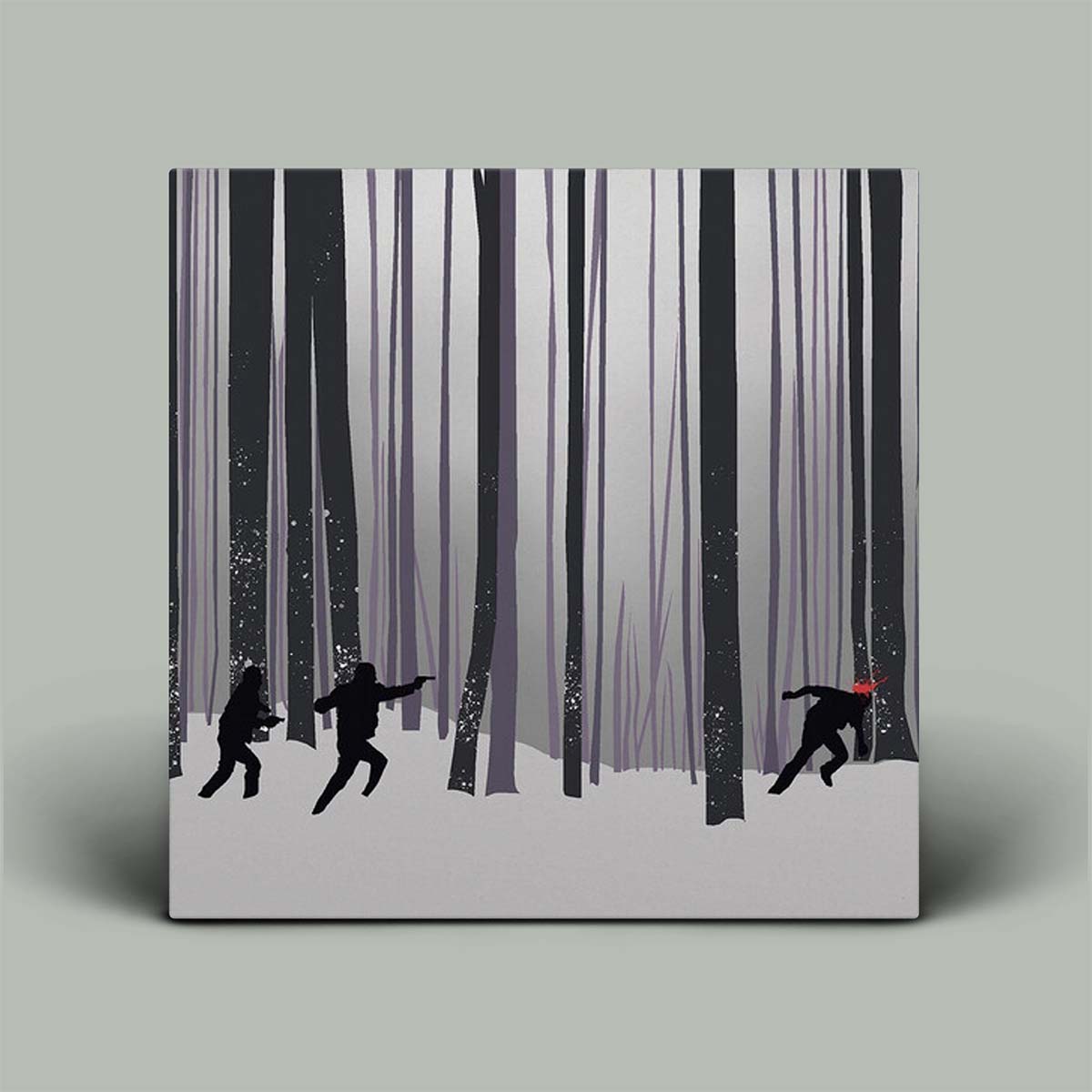 Framed artwork of silhouettes in a snowy forest on a gray background