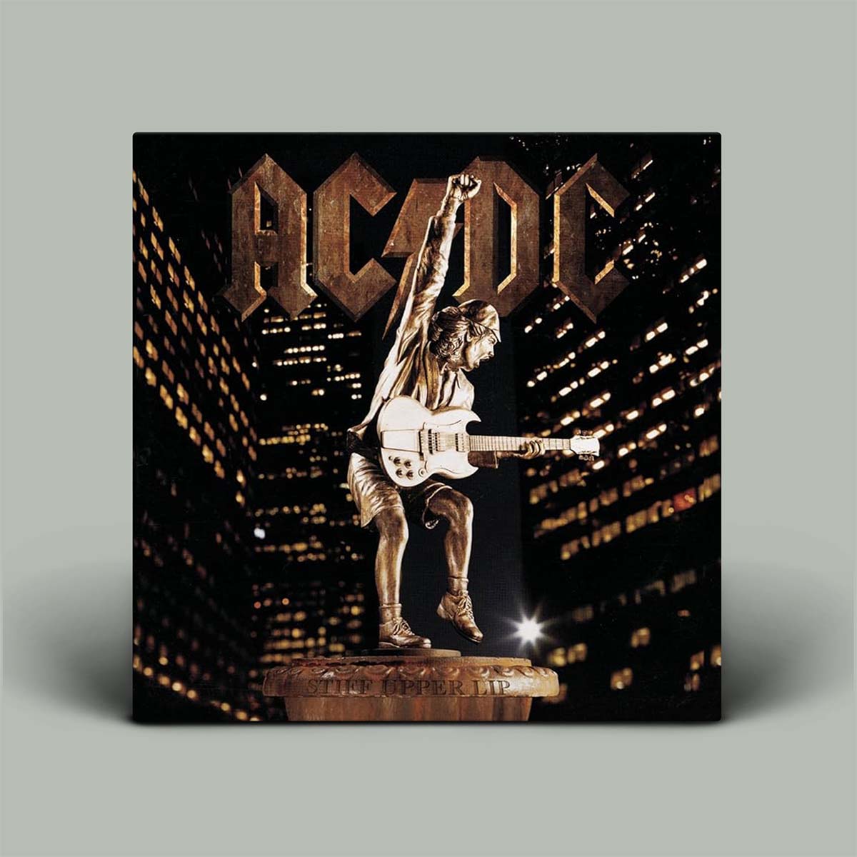 Album cover with a statue of a person playing guitar against a cityscape at night, featuring the AC/DC logo.
